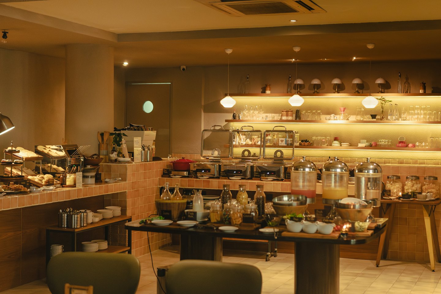 Breakfast buffet spread featuring pastries and warm food dishes.